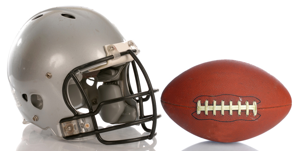 protective football helmet and leather football with reflection.